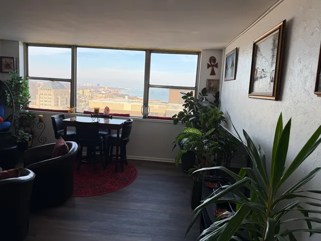 a dining room with furniture window and wooden floor