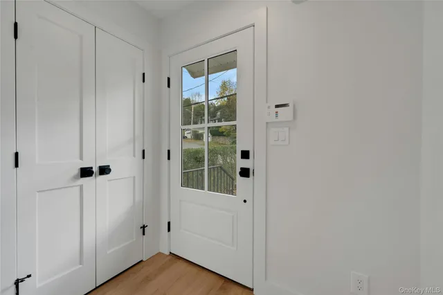 a view of a small space with wooden floor and a window