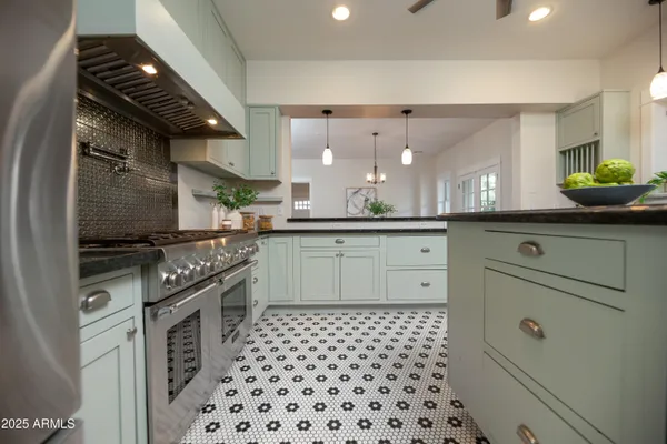 a stove top oven sitting inside of a kitchen