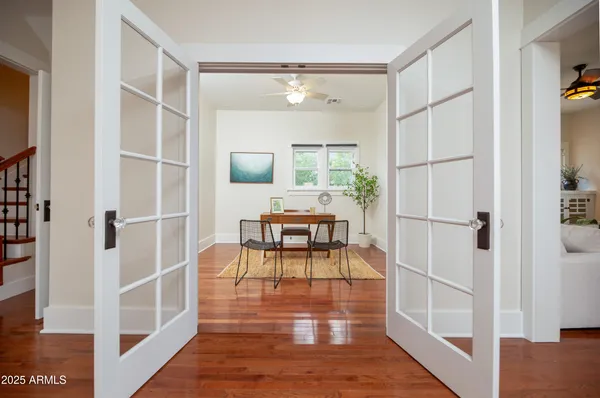 a bedroom with a bed and wooden floor