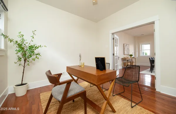 a living room with furniture and a wooden floor