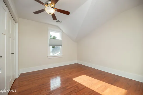 a front view of a house with a yard and palm trees