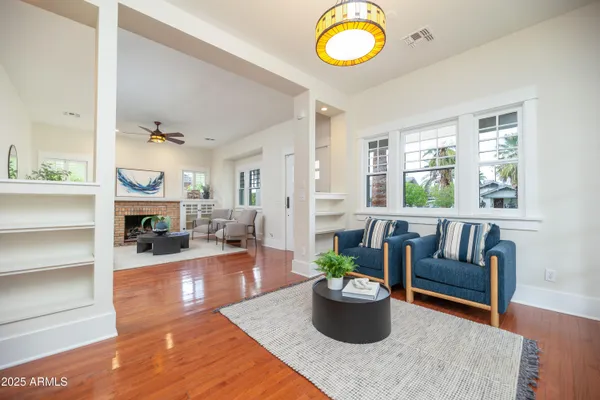a living room with furniture and a wooden floor