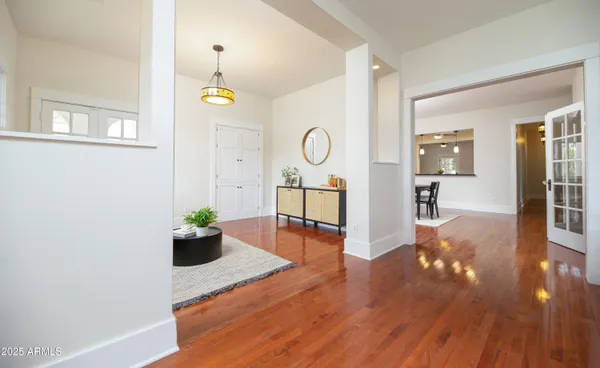 a view of a a dining room with furniture window and wooden floor