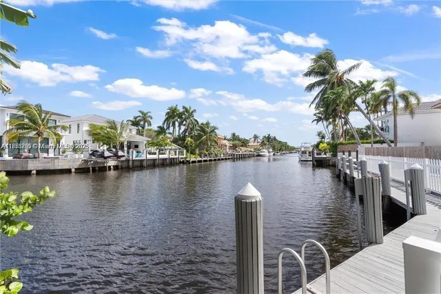 a view of a lake with boats and trees in the background