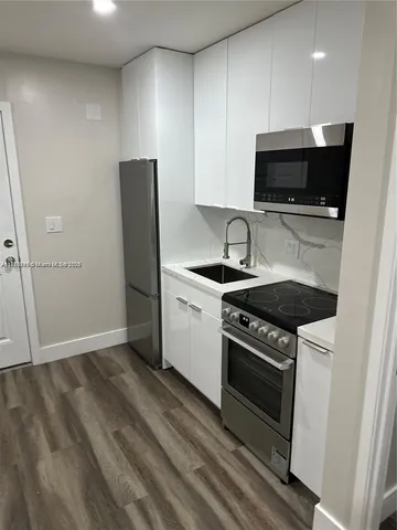 a kitchen with a stove and a microwave