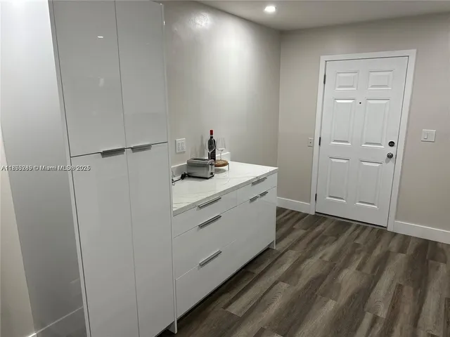 a room with a bed and a dresser