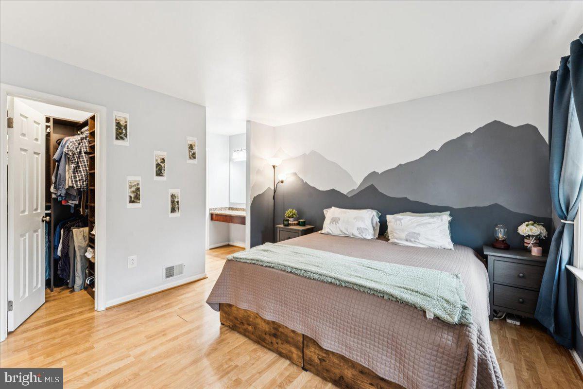 12592 Rock Ridge Road Herndon, VA 20170 - Photo 19 of 41 a bedroom with a bed and a walk in closet