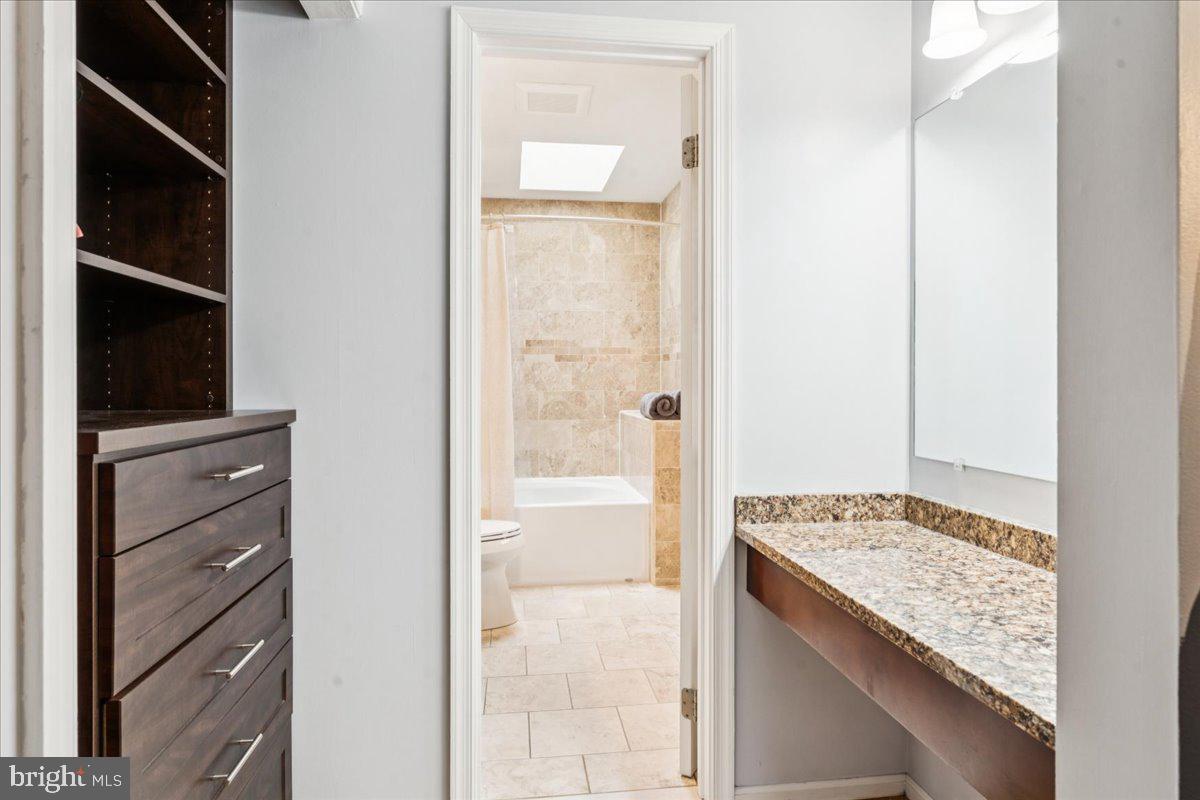 12592 Rock Ridge Road Herndon, VA 20170 - Photo 23 of 41 a bathroom with a granite countertop sink and a mirror