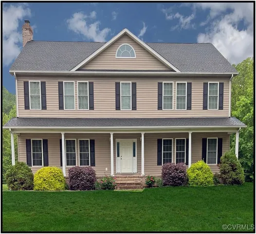 a front view of a house with garden and porch