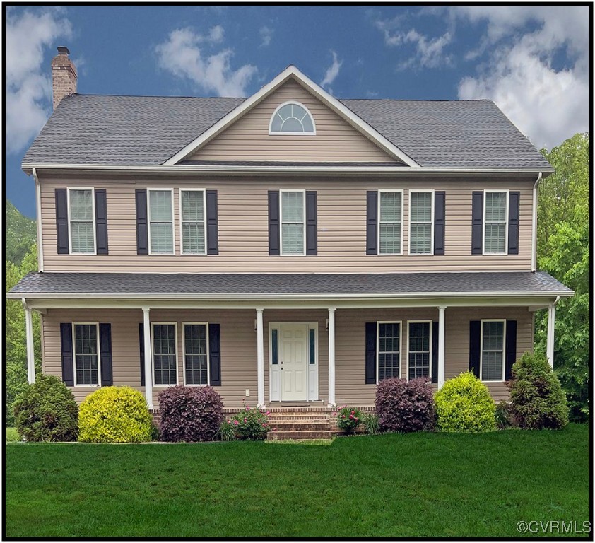 a front view of a house with garden and porch