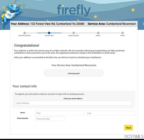 a living room with kitchen view and a chandelier