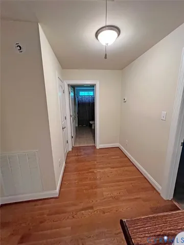 a view of a room with wooden floor