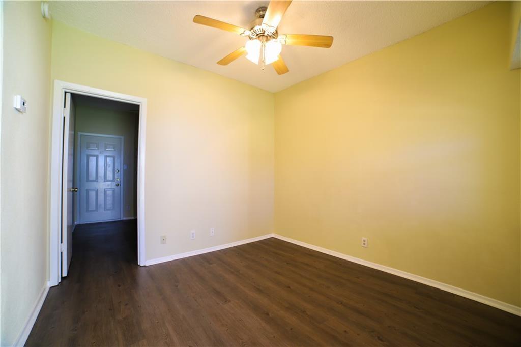 2604 Salado Street, Unit 103 Austin, TX 78705 - Photo 3 of 6 Spare room with dark wood-type flooring and ceiling fan