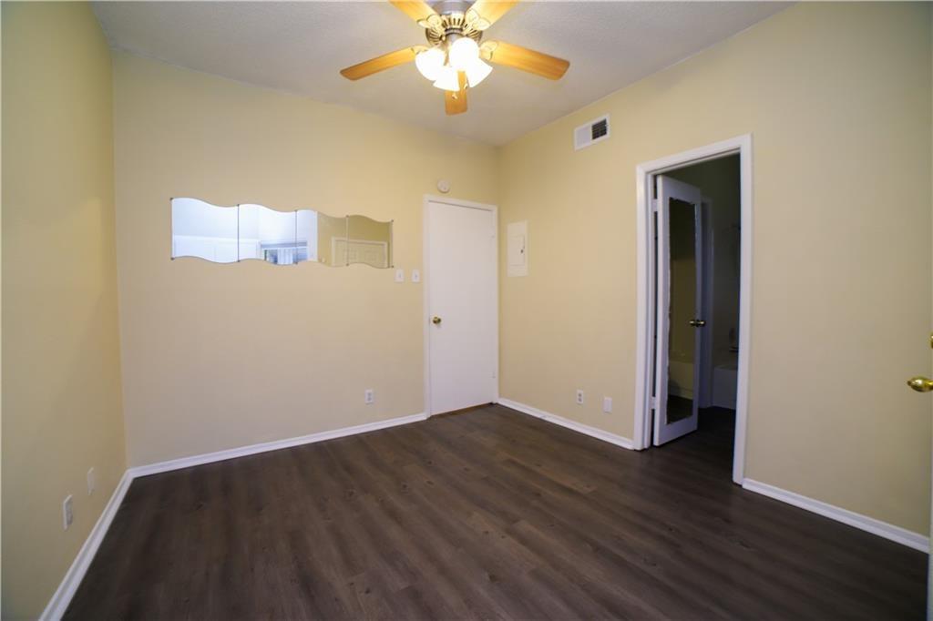2604 Salado Street, Unit 103 Austin, TX 78705 - Photo 4 of 6 Unfurnished room featuring dark wood-style floors and ceiling fan