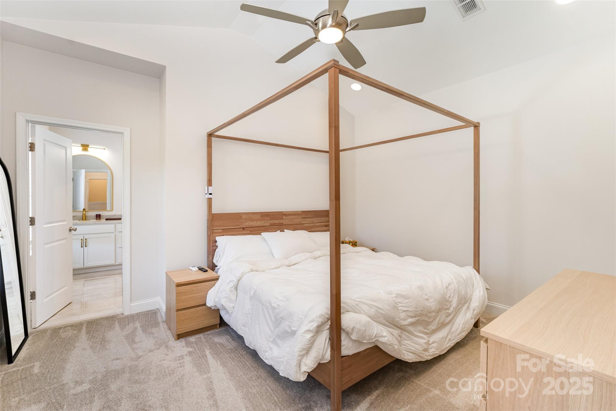 320 Lawrence Gray Road Charlotte, NC 28262 - Photo 13 of 23 a bedroom with a bed and a chandelier