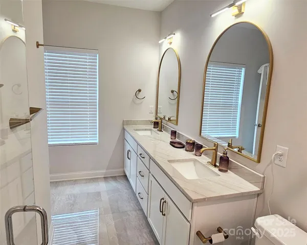 a bathroom with a double vanity sink and a mirror