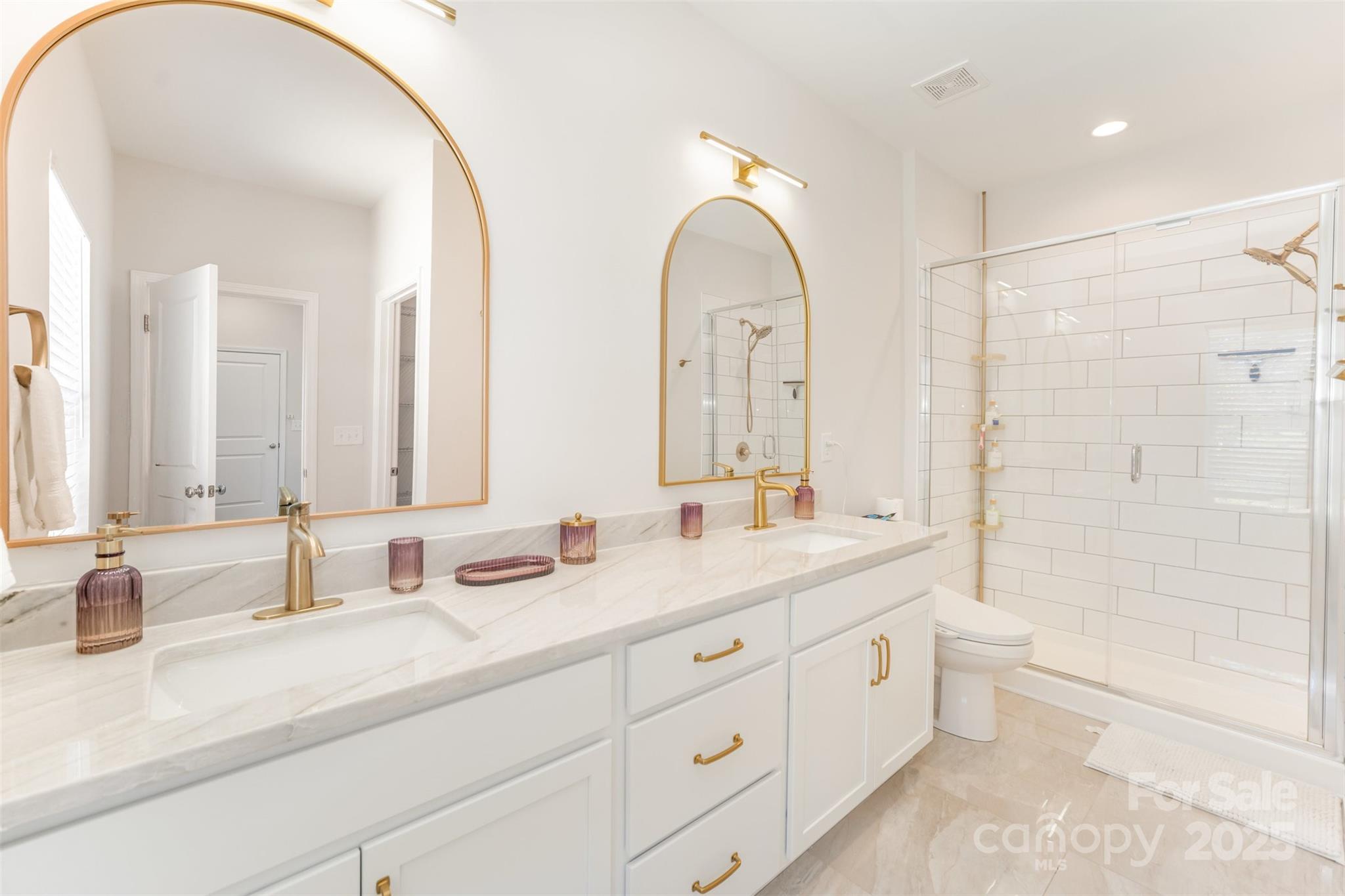 320 Lawrence Gray Road Charlotte, NC 28262 - Photo 15 of 23 a bathroom with double vanity sink a mirror and a bathtub