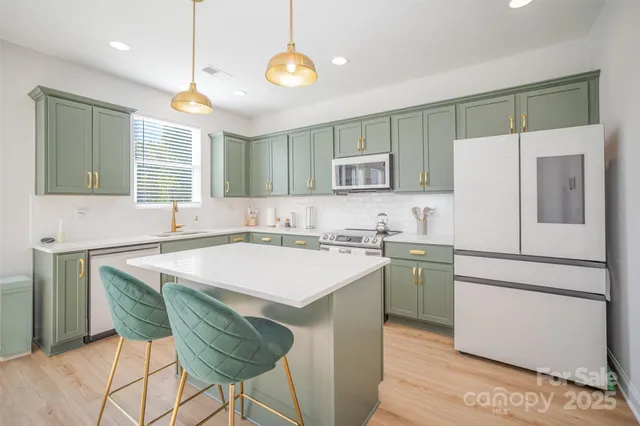 a kitchen with a stove a sink and a refrigerator