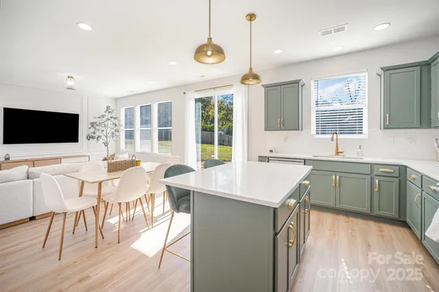 a kitchen with a sink cabinets and wooden floor