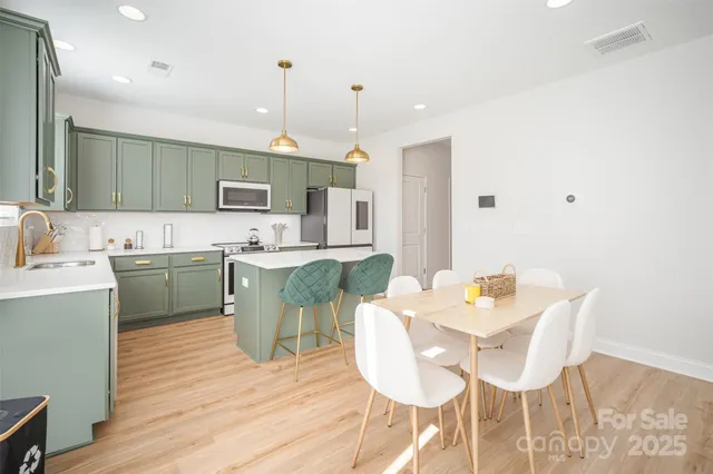 a kitchen with a sink cabinets and wooden floor