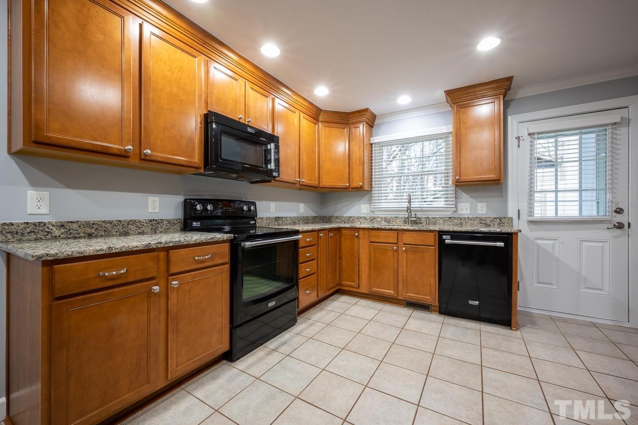 3400 Morningside Drive Raleigh, NC 27607 - Photo 11 of 21 a kitchen with stainless steel appliances granite countertop a stove a sink and a microwave