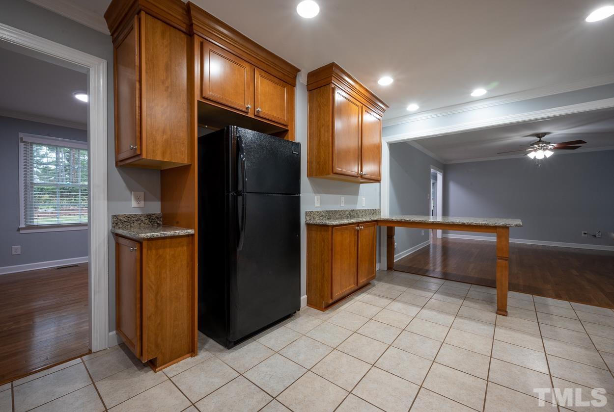 3400 Morningside Drive Raleigh, NC 27607 - Photo 12 of 21 a kitchen with granite countertop a refrigerator a stove and a sink