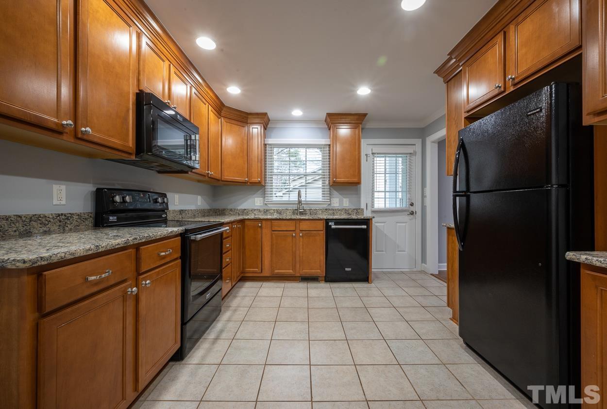 3400 Morningside Drive Raleigh, NC 27607 - Photo 13 of 21 a kitchen with stainless steel appliances granite countertop a stove a sink and a refrigerator