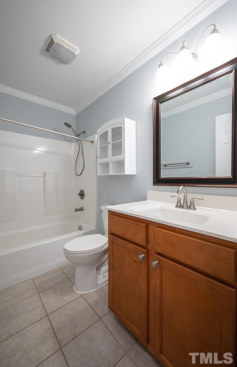 3400 Morningside Drive Raleigh, NC 27607 - Photo 14 of 21 a bathroom with a toilet a sink a mirror a bathtub and shower