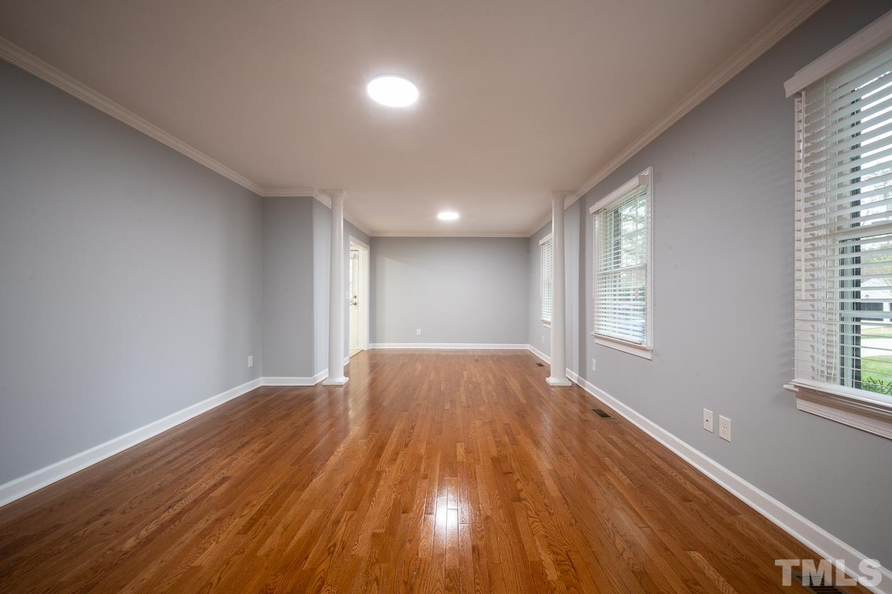 3400 Morningside Drive Raleigh, NC 27607 - Photo 5 of 21 a view of an empty room and window and wooden floor