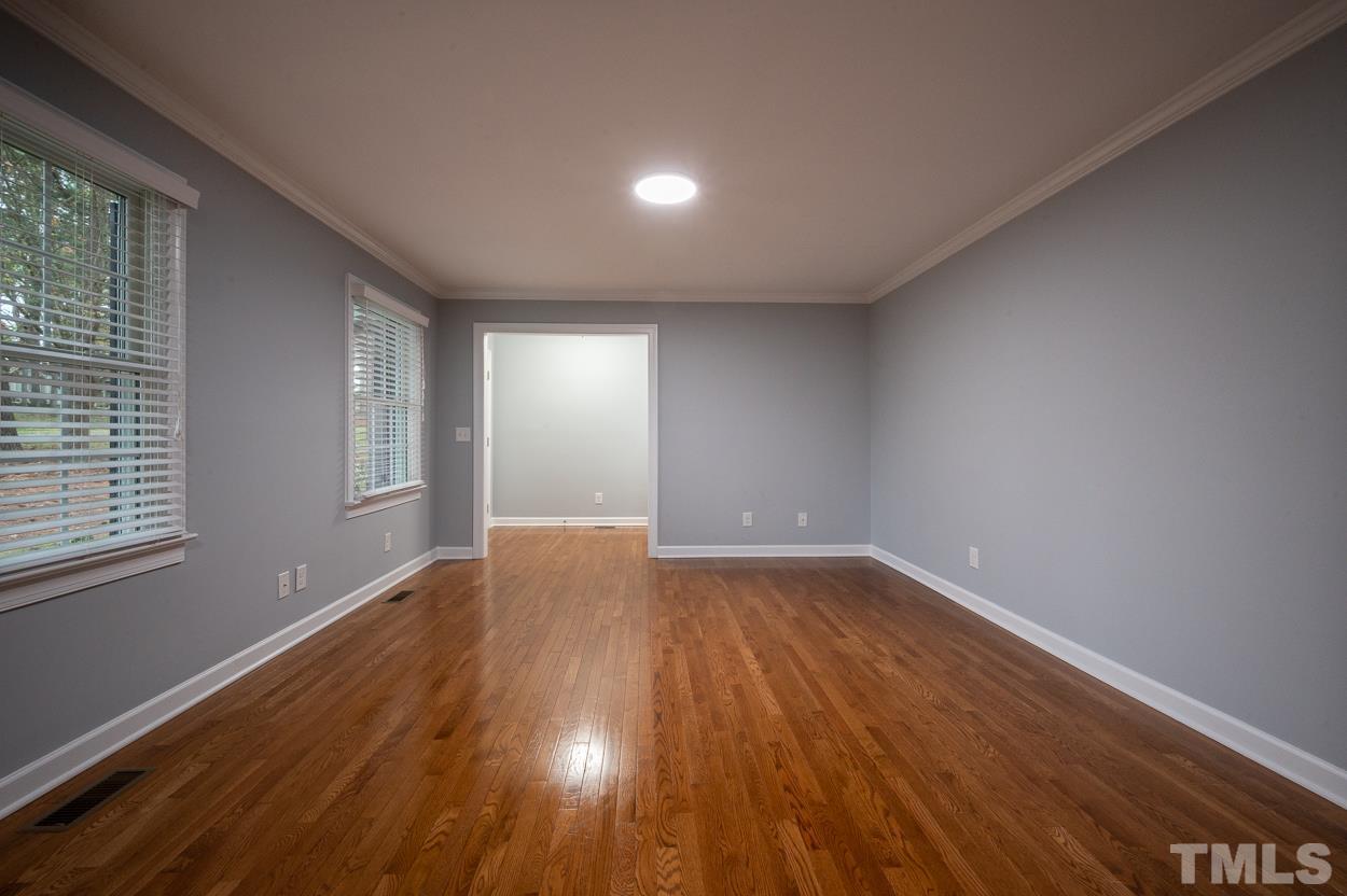 3400 Morningside Drive Raleigh, NC 27607 - Photo 7 of 21 an empty room with wooden floor and windows