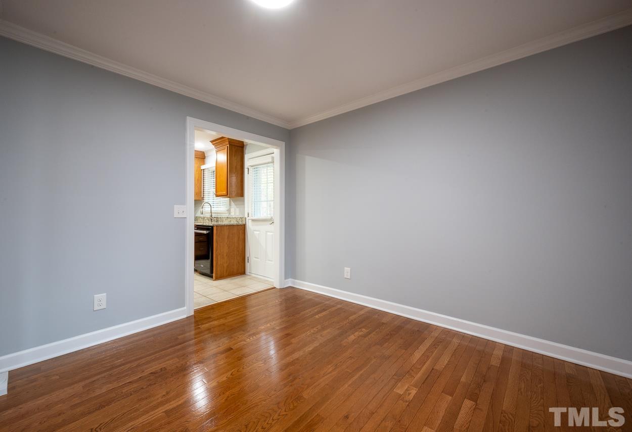 3400 Morningside Drive Raleigh, NC 27607 - Photo 8 of 21 a view of empty room with wooden floor and fan