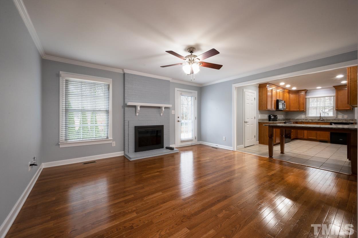 3400 Morningside Drive Raleigh, NC 27607 - Photo 10 of 21 a view of an empty room with a fireplace and a window