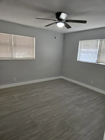 a view of wooden floor cabinets and window