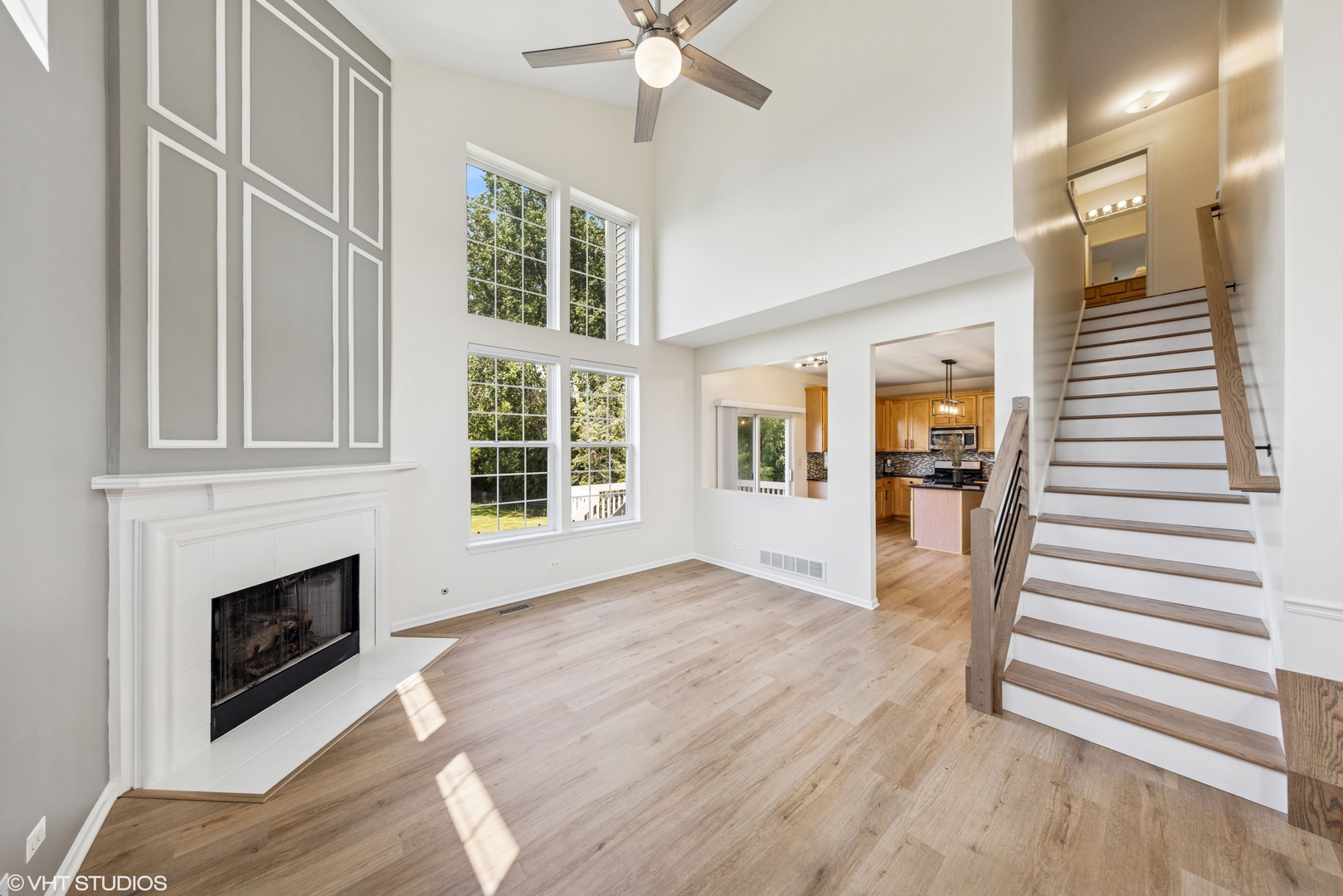 7 Edgebrook Court Algonquin, IL 60102 - Photo 2 of 18 a view of a livingroom with wooden floor a ceiling fan and windows