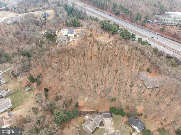 a view of a field with trees in background
