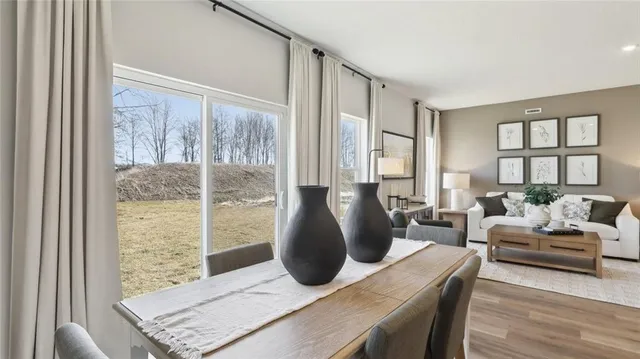 a living room with furniture and large windows