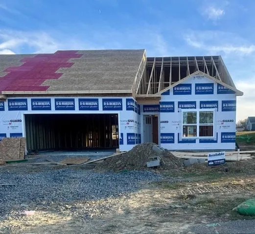 a front view of building with a yard and a garage