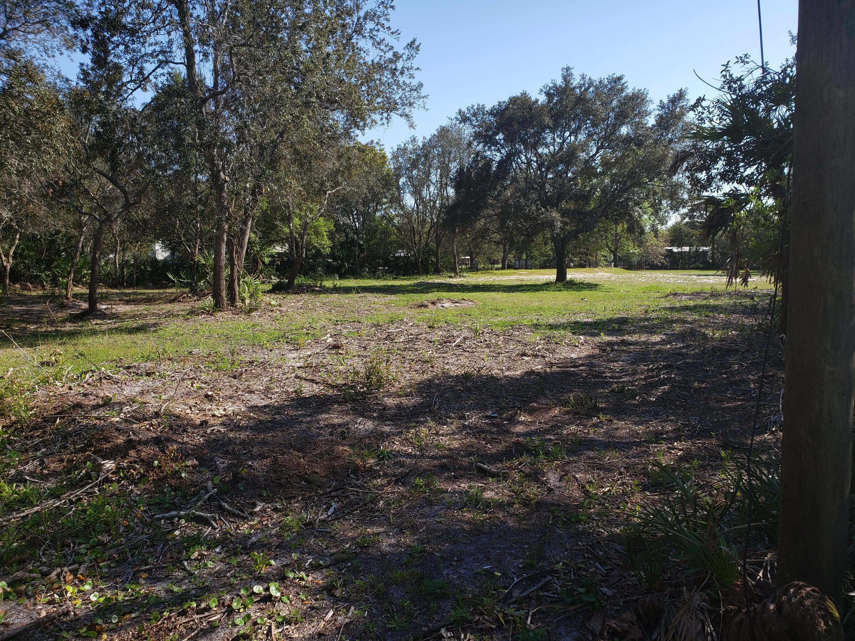 325 Dusty Road St. Augustine, FL 32095 - Photo 8 of 11 a view of a house in a yard with a trees