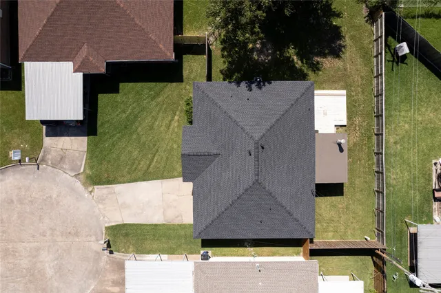 an aerial view of a house with a yard