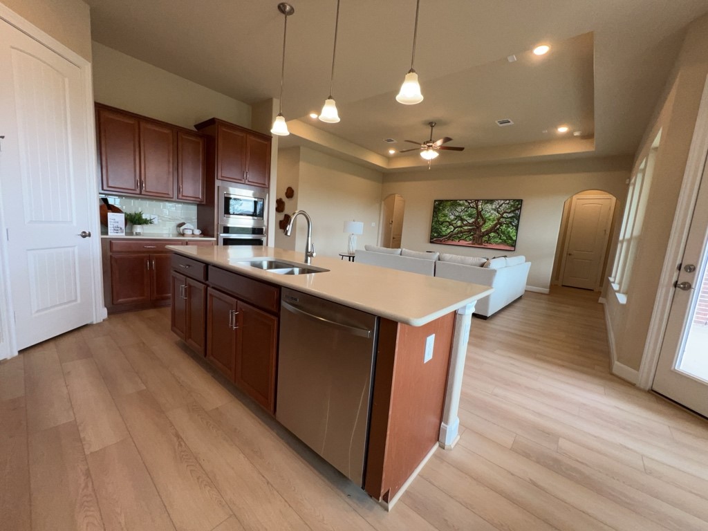 5602 Caracara Street Manvel, TX 77578 - Photo 11 of 27 a kitchen with a sink a counter space appliances and cabinets