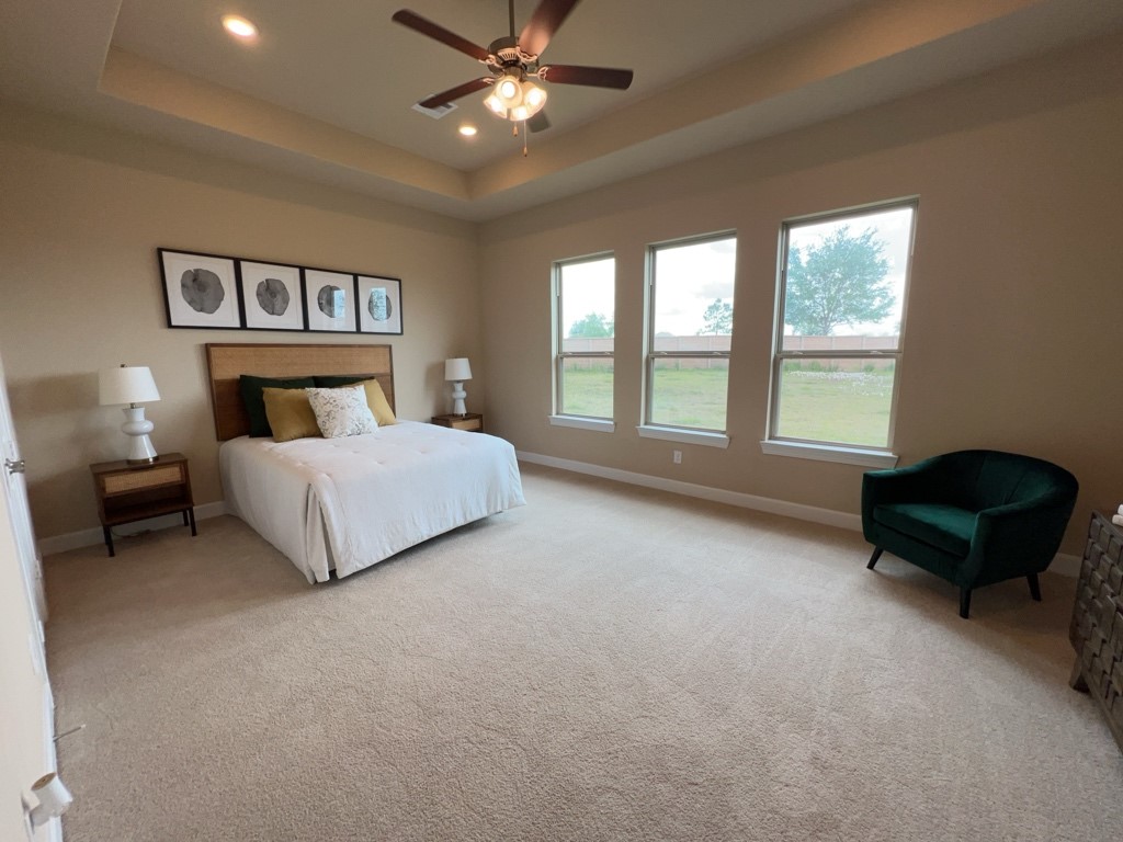 5602 Caracara Street Manvel, TX 77578 - Photo 12 of 27 a spacious bedroom with a bed and a large window