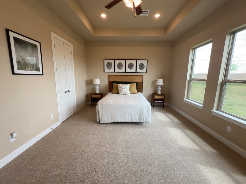 5602 Caracara Street Manvel, TX 77578 - Photo 13 of 27 a spacious bedroom with a bed and a large window