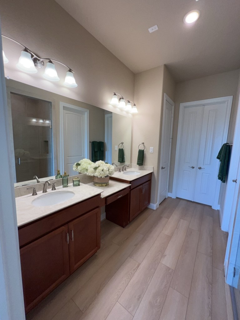 5602 Caracara Street Manvel, TX 77578 - Photo 15 of 27 a large bathroom with a double vanity sink and a mirror