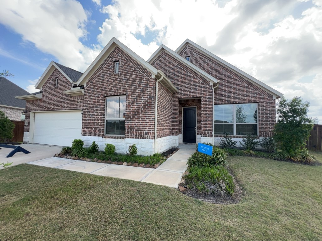 5602 Caracara Street Manvel, TX 77578 - Photo 2 of 27 a front view of a house with garden