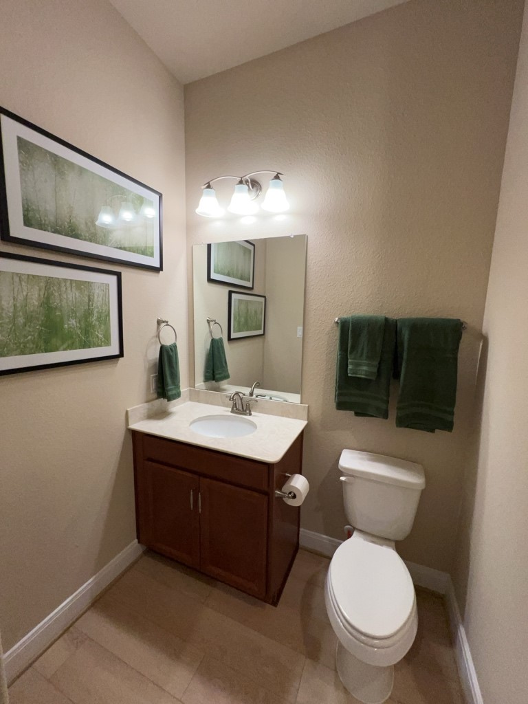 5602 Caracara Street Manvel, TX 77578 - Photo 21 of 27 a bathroom with a toilet a sink and mirror