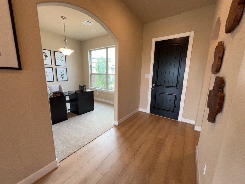 5602 Caracara Street Manvel, TX 77578 - Photo 3 of 27 a view of kitchen with furniture and wooden floor