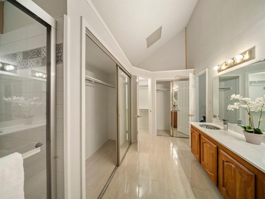 13347 Pandora Circle Dallas, TX 75238 - Photo 23 of 36 a bathroom with a double vanity sink and mirror