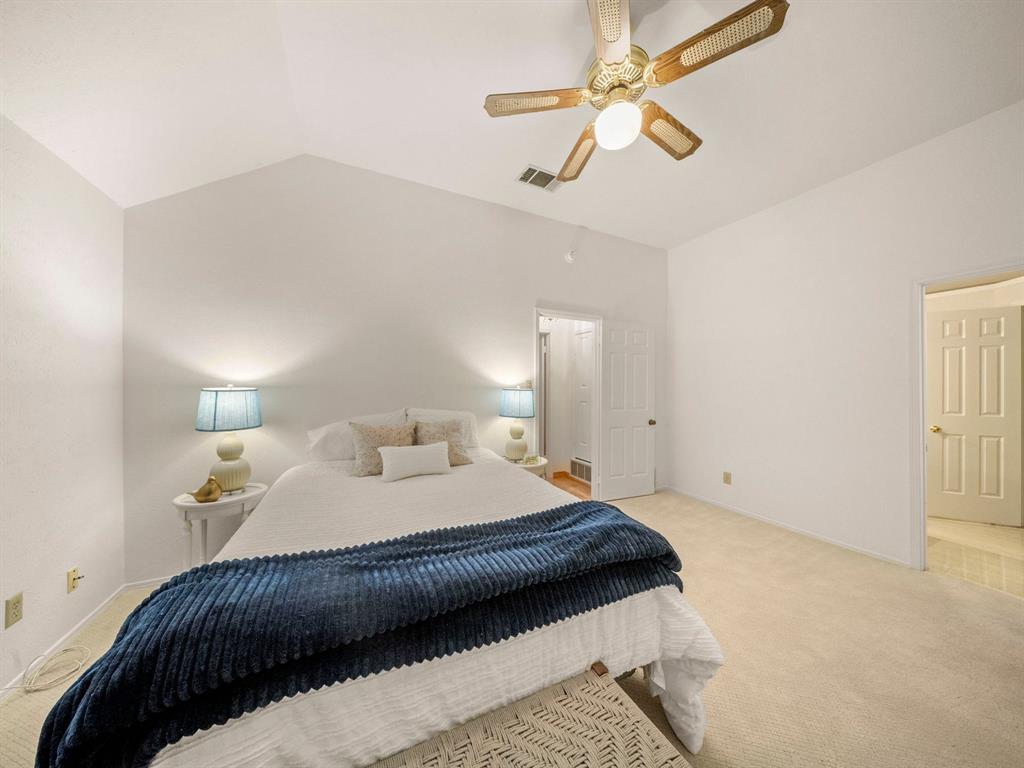 13347 Pandora Circle Dallas, TX 75238 - Photo 26 of 36 a bedroom with a bed and a ceiling fan