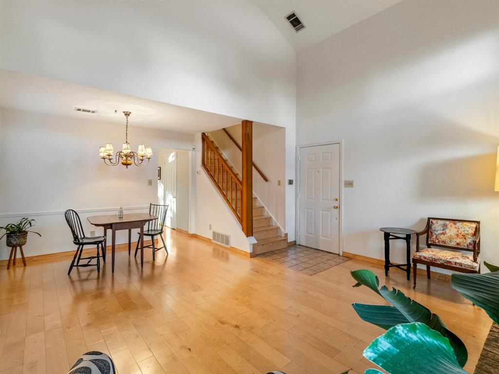 13347 Pandora Circle Dallas, TX 75238 - Photo 27 of 36 a dining room with furniture a chandelier and wooden floor